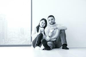 multiethnic couple enjoying morning coffee by the window photo