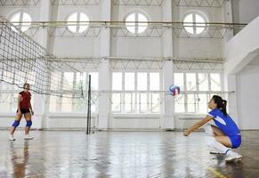 girls playing volleyball indoor game photo