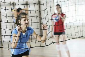 girls playing volleyball indoor game photo