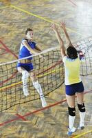 girls playing volleyball indoor game photo