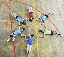 girls playing volleyball indoor game photo