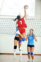girls playing volleyball indoor game photo
