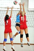 girls playing volleyball indoor game photo