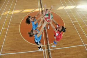 girls playing volleyball indoor game photo