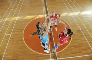 girls playing volleyball indoor game photo