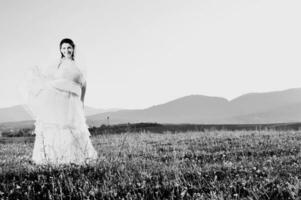 Beautiful bride outdoors in black and white photo