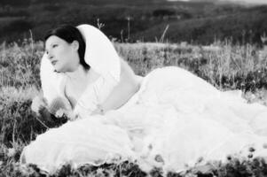 Beautiful bride outdoors in black and white photo