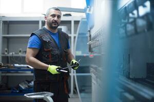 A smart factory worker or engineer makes machines in a production workshop. The concept of industry and engineering. Selective focus photo