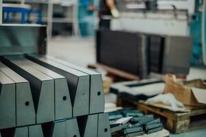 A smart factory worker or engineer makes machines in a production workshop. The concept of industry and engineering. Selective focus photo