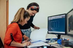 Within the heavy industry, a factory industrial engineer measures with a caliper and on a personal computer Designs a 3D model photo