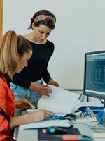 Within the heavy industry, a factory industrial engineer measures with a caliper and on a personal computer Designs a 3D model photo