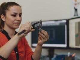 Within the heavy industry, a factory industrial engineer measures with a caliper and on a personal computer Designs a 3D model photo