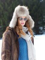 portrait of beautiful young redhair woman in snow scenery photo