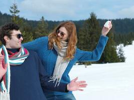 happy young couple having fun on fresh show on winter vacation photo