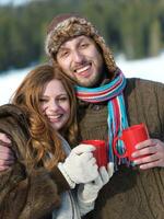 happy young couple drink warm tea at winter photo