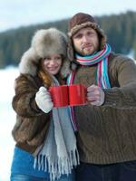 happy young couple drink warm tea at winter photo