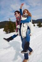 happy young couple having fun on fresh show on winter vacation photo