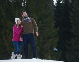 couple having fun and walking in snow shoes photo