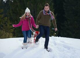 couple having fun and walking in snow shoes photo