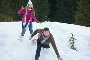 couple having fun and walking in snow shoes photo