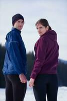 couple jogging outside on snow photo