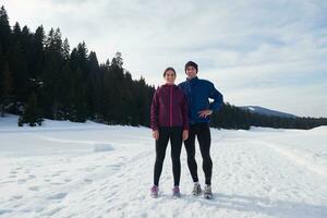 couple jogging outside on snow photo