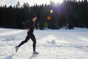 jogging on snow in forest photo