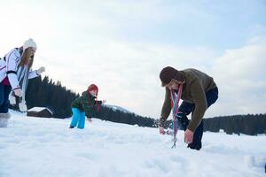 happy family playing together in snow at winter photo