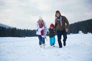 happy family playing together in snow at winter photo