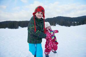 kids walking on snow photo