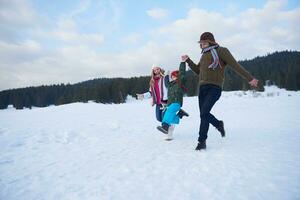 happy family playing together in snow at winter photo