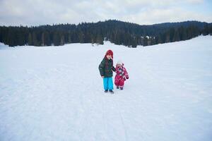 kids walking on snow photo