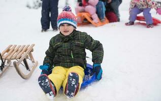 children group  having fun and play together in fresh snow photo