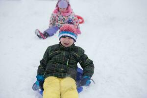 children group  having fun and play together in fresh snow photo