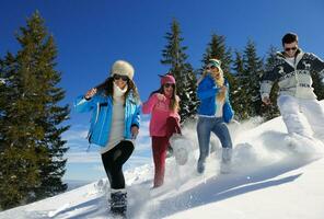 friends have fun at winter on fresh snow photo