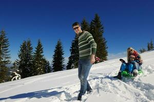 family having fun on fresh snow at winter vacation photo