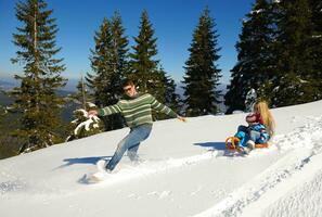 family having fun on fresh snow at winter photo