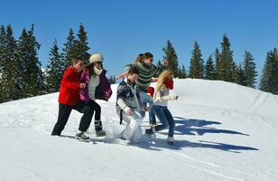 friends have fun at winter on fresh snow photo