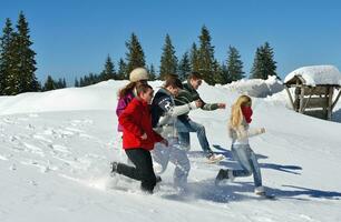 friends have fun at winter on fresh snow photo