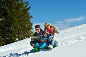 family having fun on fresh snow at winter photo