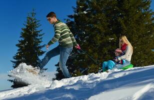 family having fun on fresh snow at winter photo