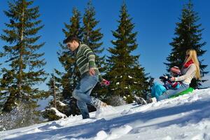 family having fun on fresh snow at winter photo