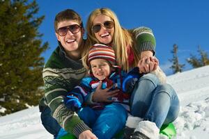 family having fun on fresh snow at winter photo