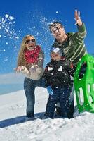 family having fun on fresh snow at winter photo