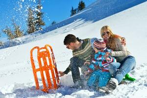 family having fun on fresh snow at winter photo