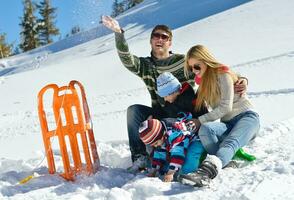 family having fun on fresh snow at winter photo