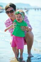 mom and baby on beach  have fun photo