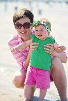 mom and baby on beach  have fun photo