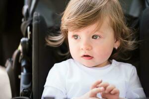 baby girl sitting in the pram photo