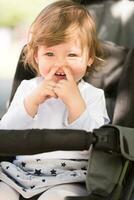 baby girl sitting in the pram photo